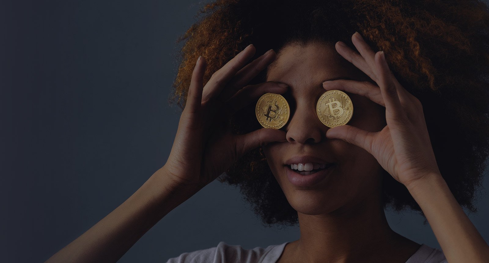 Woman holding Bitcoins in Front of her Eyes Woman holding Bitcoins in front of her Eyes